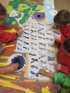 Groupe d'enfants qui peignent avec des pochoirs