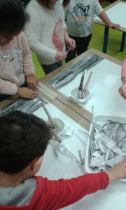 Les enfants fabriquent un ciel avec des bandes de papier gris